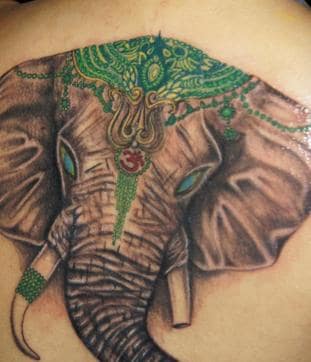 A girl with a tattoo of Ganesha on her back.