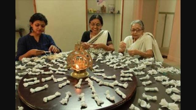 Lakshmi with her mother and grandmother involved in making wicks for lamps. (Lakshmi Menon) Lakshmi with her mother and grandmother involved in making wicks for lamps. (Lakshmi Menon)