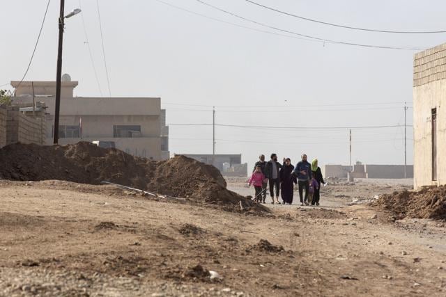 Civilians fleeing fighting between Islamic State group militants and Iraqi forces cross the frontline from the Samah neighborhood of Mosul in this Nov. 6, 2016 photo taken in Gogjali, Iraq. (AP) Civilians fleeing fighting between Islamic State group militants and Iraqi forces cross the frontline from the Samah neighborhood of Mosul in this Nov. 6, 2016 photo taken in Gogjali, Iraq. (AP)