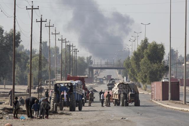 Civilians with tractors distribute food to people fleeing Mosul as fighting rages nearby in the fight between Islamic State group militants and Iraqi forces in Gogjali, Iraq. (AP Photo) Civilians with tractors distribute food to people fleeing Mosul as fighting rages nearby in the fight between Islamic State group militants and Iraqi forces in Gogjali, Iraq. (AP Photo)