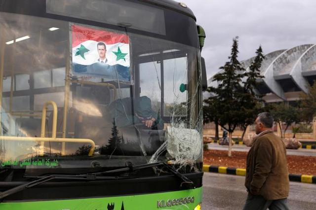A bus driver waits to evacuate people from a rebel pocket in Aleppo, in the government-controlled al-Hamadaniah Stadium of Aleppo, Syria. (Reuters)