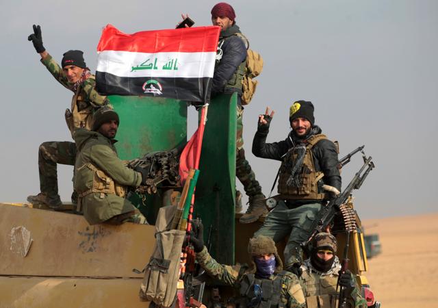 Shiite fighters show the victory sign as they advance further into Mosul. (AFP photo) Shiite fighters show the victory sign as they advance further into Mosul. (AFP photo)