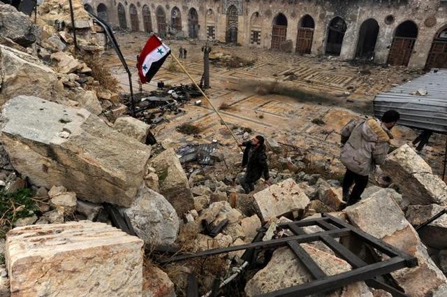 A member of forces loyal to Syria's President Bashar al-Assad attempts to erect the Syrian national flag inside the Umayyad mosque, in the government-controlled area of Aleppo. A member of forces loyal to Syria's President Bashar al-Assad attempts to erect the Syrian national flag inside the Umayyad mosque, in the government-controlled area of Aleppo.