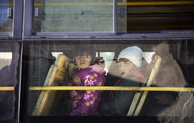 Children inside a bus during an evacuation operation. (AFP) Children inside a bus during an evacuation operation. (AFP)