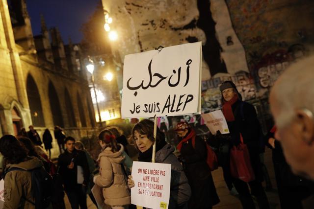A woman holds a poster reading "I'm Aleppo" during a gathering in a show of support for Aleppo citizens, in Paris. (AP Photo)