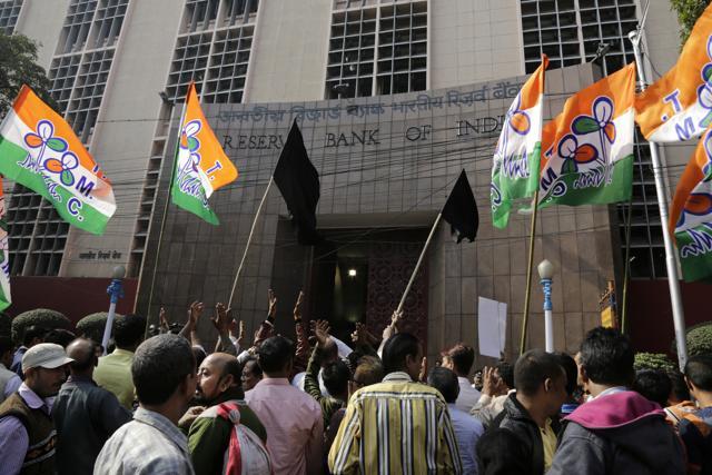 Activists and supporters of Trinamool Congress party show black flags and shout slogans against demonetisation as Urjit Patel, the governor of Reserve Bank of India, visits a branch in Kolkata. (AP) Activists and supporters of Trinamool Congress party show black flags and shout slogans against demonetisation as Urjit Patel, the governor of Reserve Bank of India, visits a branch in Kolkata. (AP)