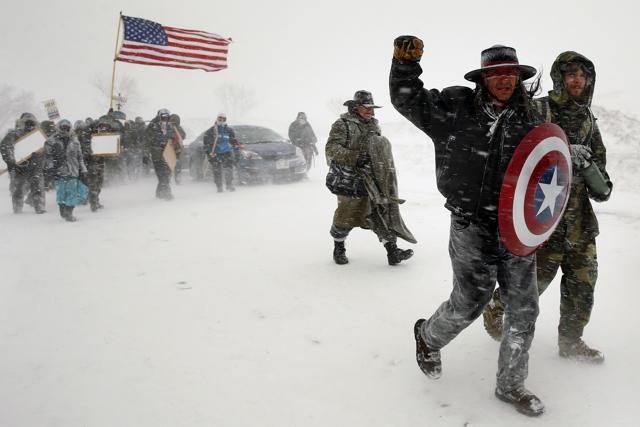 Veterans join activists in a march to Backwater Bridge just outside the Oceti Sakowin camp to demonstrate against plans to pass the Dakota Access pipeline adjacent to the Standing Rock Indian Reservation, North Dakota, December 5, 2016 (REUTERS) Veterans join activists in a march to Backwater Bridge just outside the Oceti Sakowin camp to demonstrate against plans to pass the Dakota Access pipeline adjacent to the Standing Rock Indian Reservation, North Dakota, December 5, 2016 (REUTERS)