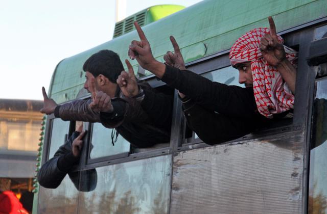 Syrians, who were evacuated from rebel-held neighbourhoods in the embattled city of Aleppo, gesture as they arrive in the opposition-controlled Khan al-Aassal region where humanitarian groups will transport the civilians to temporary camps on the outskirts of Idlib and the wounded to field hospitals. (AFP) Syrians, who were evacuated from rebel-held neighbourhoods in the embattled city of Aleppo, gesture as they arrive in the opposition-controlled Khan al-Aassal region where humanitarian groups will transport the civilians to temporary camps on the outskirts of Idlib and the wounded to field hospitals. (AFP)