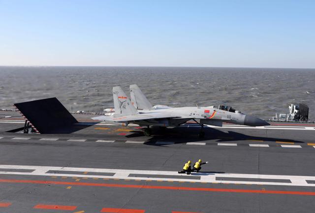A Chinese J-15 fighter jet preparing to take off from the deck of the Liaoning aircraft carrier during military drills in the Bohai Sea, off China's northeast coast. (AFP Photo)