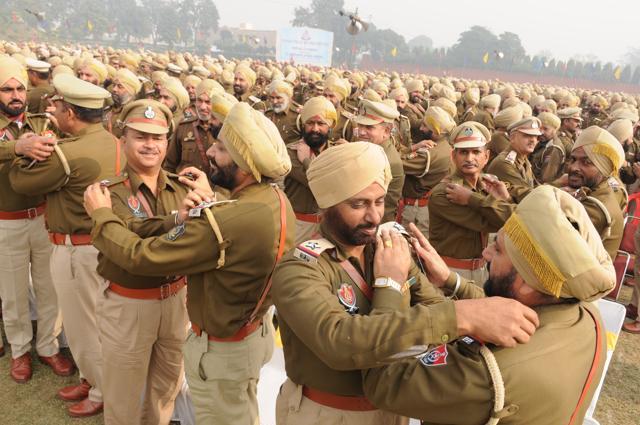Punjab police officials putting promotion badges on each other during pipping ceremony in Jalandhar, on Thursday. (Pradeep pandit/HT Photo)