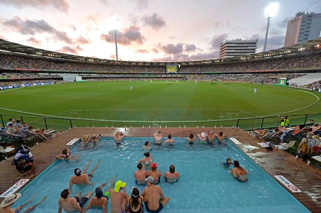 Fans are seen enjoying themselves in the pool as the sun sets at dusk during day one of the first Test match between Australia and Pakistan at The Gabba on December 15. (Getty Images) Fans are seen enjoying themselves in the pool as the sun sets at dusk during day one of the first Test match between Australia and Pakistan at The Gabba on December 15. (Getty Images)