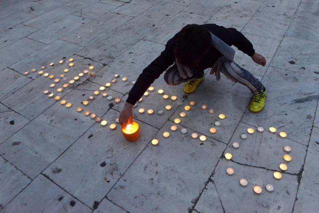A Syrian boy lights candles and write the word "Aleppo" during a demonstration in support of the inhabitants of the embattled Syrian city of Aleppo, in Thessaloniki. (AFP Photo)