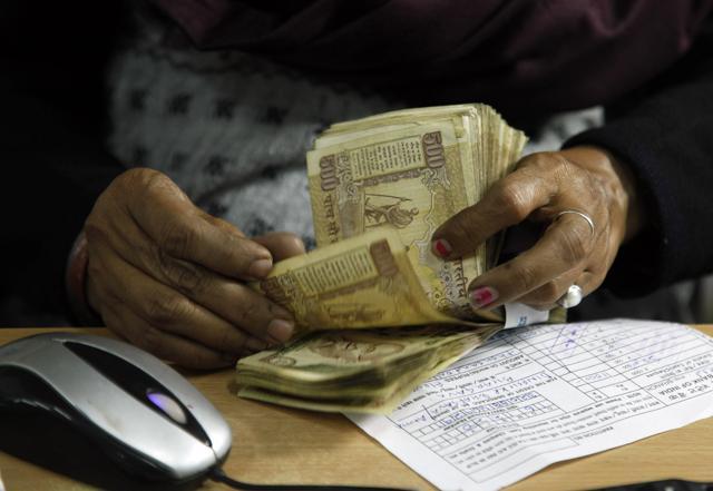 A cashier counts scrapped Rs 500 notes at a bank in Allahabad. (AP File Photo) A cashier counts scrapped Rs 500 notes at a bank in Allahabad. (AP File Photo)