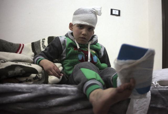 A Syrian child, evacuated from Aleppo, sits in a field hospital bed near Idlib, Syria. (AP Photo)