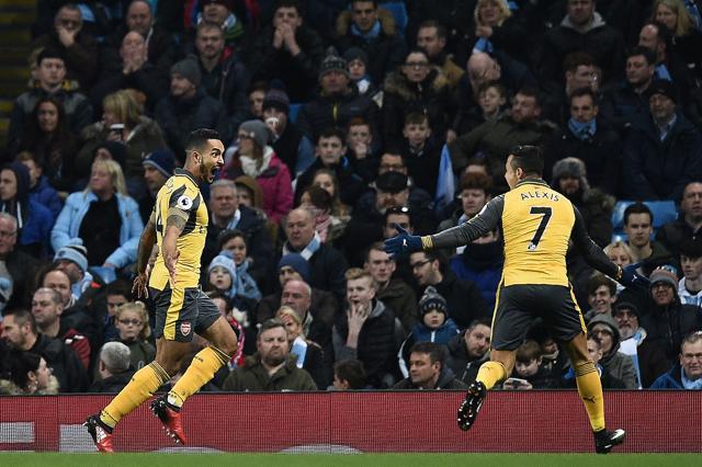 Arsenal's English midfielder Theo Walcott (L) celebrates scoring his team's first goal. (AFP) Arsenal's English midfielder Theo Walcott (L) celebrates scoring his team's first goal. (AFP)