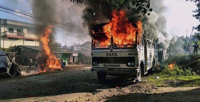 Vehicles are seen burning after being set alight by protesters in Imphal. (AFP) Vehicles are seen burning after being set alight by protesters in Imphal. (AFP)