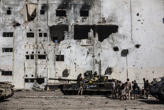 Fighters of the Libyan forces affiliated to the Tripoli government rest and reload weapons during an offensive against Islamic State militants, in Sirte. (AP File Photo) Fighters of the Libyan forces affiliated to the Tripoli government rest and reload weapons during an offensive against Islamic State militants, in Sirte. (AP File Photo)