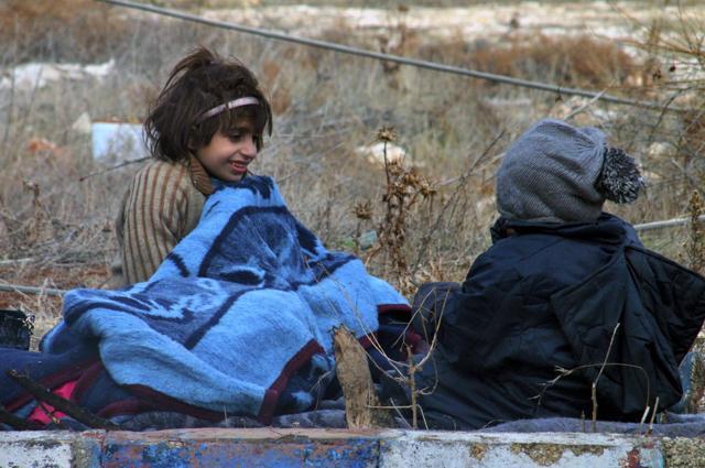 This image released by Aleppo 24, shows children of eastern Aleppo sitting on the ground in western rural Aleppo, Syria. As the last holdouts leave the rebel-held enclave in Aleppo, they speak of their love for the city despite witnessing so much destruction and death. (AP Photo) This image released by Aleppo 24, shows children of eastern Aleppo sitting on the ground in western rural Aleppo, Syria. As the last holdouts leave the rebel-held enclave in Aleppo, they speak of their love for the city despite witnessing so much destruction and death. (AP Photo)