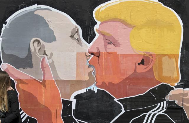A couple kisses in front of graffiti depicting Russian President Vladimir Putin (left) and Republican presidential candidate Donald Trump, on the walls of a bar in the old town in Vilnius, Lithuania. (AP Photo) A couple kisses in front of graffiti depicting Russian President Vladimir Putin (left) and Republican presidential candidate Donald Trump, on the walls of a bar in the old town in Vilnius, Lithuania. (AP Photo)