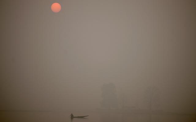 A Kashmiri fisherman rows his boat on Dal Lake at sunset on a cold, winter's day in Srinagar. (AFP File Photo) A Kashmiri fisherman rows his boat on Dal Lake at sunset on a cold, winter's day in Srinagar. (AFP File Photo)