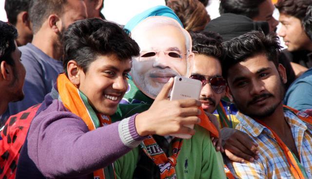 BJP party workers take a selfie at the BJYM rally at the grain market on Jalandhar Bypass in Ludhiana on Sunday. (Jagtinder Singh Grewal / HT Photo)