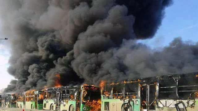 In this photo released by the Syrian official news agency SANA, smoke rises in green government buses, in Idlib province, Syria. (AP) In this photo released by the Syrian official news agency SANA, smoke rises in green government buses, in Idlib province, Syria. (AP)