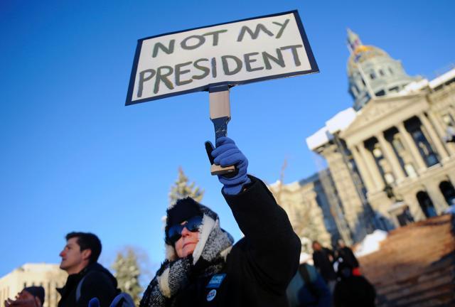 A protestor holds a sign during a demonstration against US President-elect Donald Trump outside the Colorado Capitol building. (AFP photo) A protestor holds a sign during a demonstration against US President-elect Donald Trump outside the Colorado Capitol building. (AFP photo)