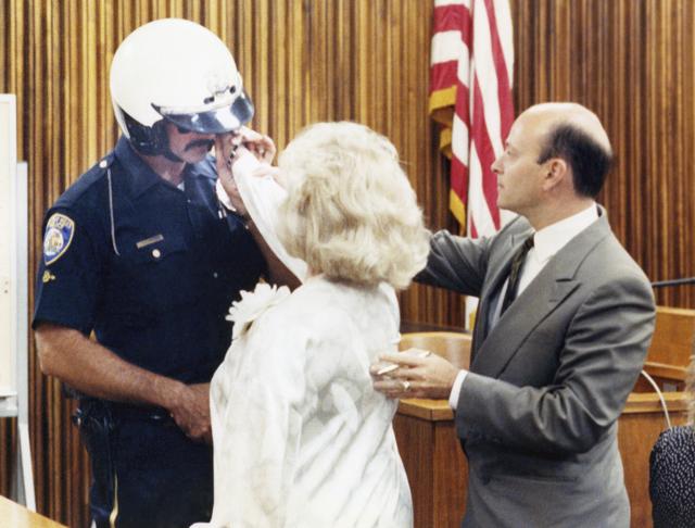 In a September 14, 1989 file photo, defence attorney William Graysen, right, positions the hand of Zsa Zsa Gabor on the face of Beverly Hills Police Officer Paul Kramer during a reenactment of the June 14 incident that resulted in Miss Gabor's arrest. (AP) In a September 14, 1989 file photo, defence attorney William Graysen, right, positions the hand of Zsa Zsa Gabor on the face of Beverly Hills Police Officer Paul Kramer during a reenactment of the June 14 incident that resulted in Miss Gabor's arrest. (AP)