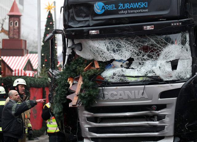 Berlin : Firefighters stand next to a damaged truck in Berlin, Germany,Tuesday Dec. 20, 2016. The truck ran into a crowded Christmas market the evening before and killed several people. (AP Photo) Berlin : Firefighters stand next to a damaged truck in Berlin, Germany,Tuesday Dec. 20, 2016. The truck ran into a crowded Christmas market the evening before and killed several people. (AP Photo)