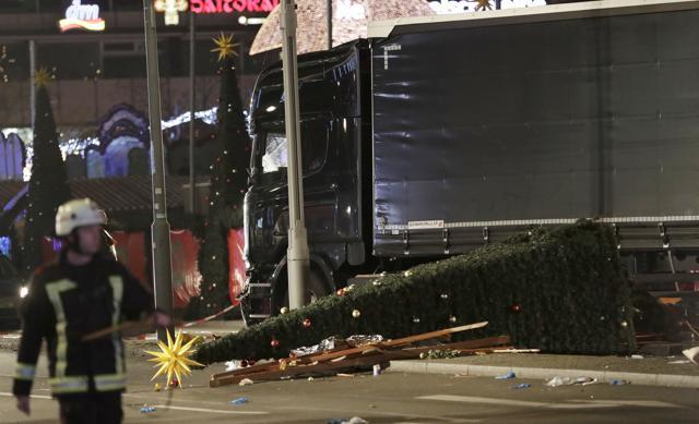 A firefighter walks passed a truck which ran into a crowded Christmas market. (AP Photo)