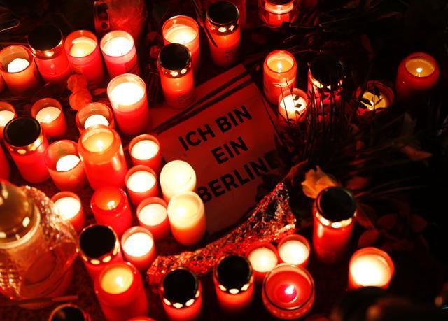 A sign quoting John F Kennedy's sentence "I am a Berliner" lies inmid candles at a makeshift memorial in front of the Kaiser-Wilhelm-Gedaechtniskirche (Kaiser Wilhelm Memorial Church), two days after an attack at the nearby Christmas market in central Berlin. (AFP Photo) A sign quoting John F Kennedy's sentence "I am a Berliner" lies inmid candles at a makeshift memorial in front of the Kaiser-Wilhelm-Gedaechtniskirche (Kaiser Wilhelm Memorial Church), two days after an attack at the nearby Christmas market in central Berlin. (AFP Photo)