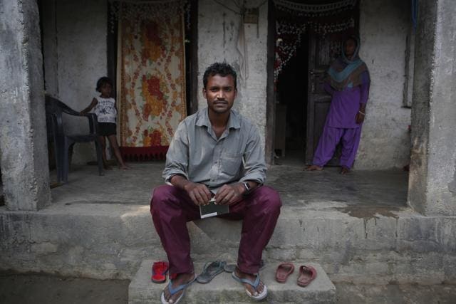 Mohammed Tohit sits in front of his house holding his passport in Belhi Village, Nepal. (AP photo) Mohammed Tohit sits in front of his house holding his passport in Belhi Village, Nepal. (AP photo)
