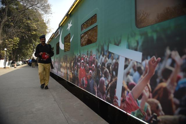 A Pakistan policeman walks past a Christmas-themed train. (AFP) A Pakistan policeman walks past a Christmas-themed train. (AFP)