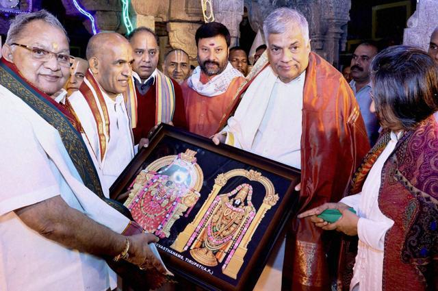 Sri Lankan Prime Minister Ranil Wickremesinghe (R) and his wife Maitree being presented with a frame of Lord Venkateswara by Tirumala Tirupati Devasthanam chairman Chadalawada Krishnamurthy. (PTI photo) Sri Lankan Prime Minister Ranil Wickremesinghe (R) and his wife Maitree being presented with a frame of Lord Venkateswara by Tirumala Tirupati Devasthanam chairman Chadalawada Krishnamurthy. (PTI photo)