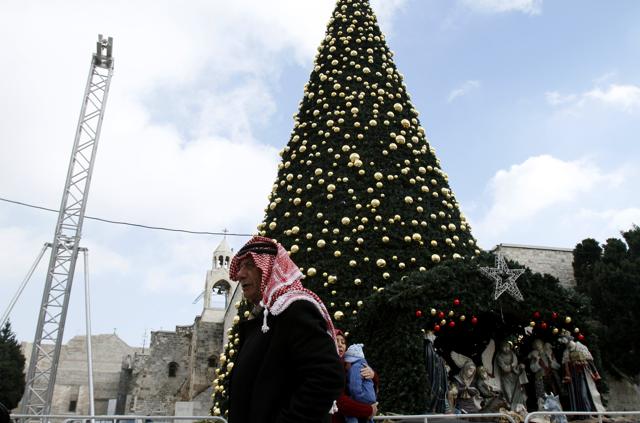 A Palestinian man walks past a Christmas tree at the Manger Square near the Church of the Nativity, revered as the site of Jesus Christ’s birth, on December 20, 2016 in the biblical West Bank town of Bethlehem. (AFP) A Palestinian man walks past a Christmas tree at the Manger Square near the Church of the Nativity, revered as the site of Jesus Christ’s birth, on December 20, 2016 in the biblical West Bank town of Bethlehem. (AFP)