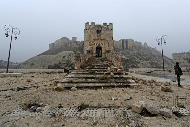 A member of forces loyal to Syria's President Bashar al-Assad stands in front of Aleppo's historic citadel. (Reuters File/Omar Sanadiki) A member of forces loyal to Syria's President Bashar al-Assad stands in front of Aleppo's historic citadel. (Reuters File/Omar Sanadiki)