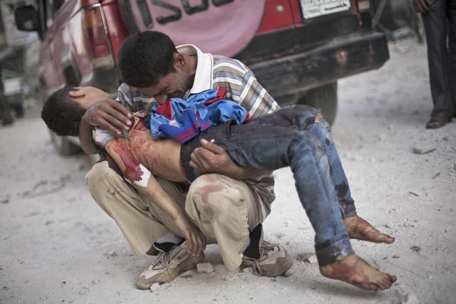 A man cries while holding the body of his son near Dar El Shifa hospital in Aleppo, Syria. (AP Photo) A man cries while holding the body of his son near Dar El Shifa hospital in Aleppo, Syria. (AP Photo)