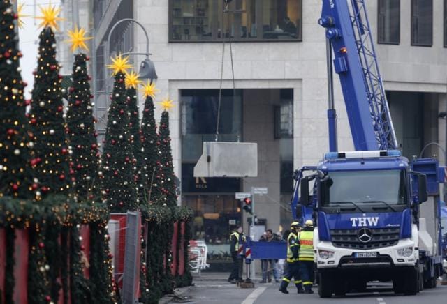 Workers place concrete barriers outside the Christmas market at Breitscheid square. (Reuters) Workers place concrete barriers outside the Christmas market at Breitscheid square. (Reuters)