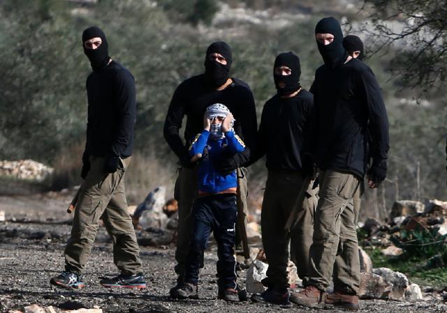 Masked members of the Israeli security forces briefly detain a Palestinian boy during clashes following a demonstration against the expropriation of Palestinian land by Israel in the village of Kfar Qaddum, near Nablus, in the occupied West Bank. (AFP) Masked members of the Israeli security forces briefly detain a Palestinian boy during clashes following a demonstration against the expropriation of Palestinian land by Israel in the village of Kfar Qaddum, near Nablus, in the occupied West Bank. (AFP)