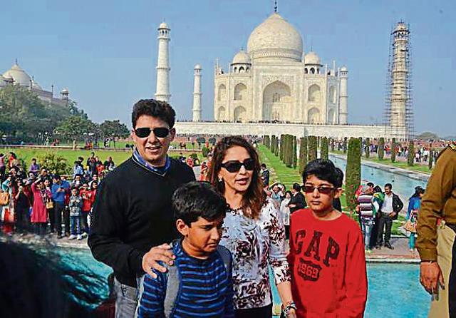 Madhuri Dixit along with her husband Dr Nene and two sons pose for the lens at the Taj Mahal in Agra on Sunday. (HT Photo)
