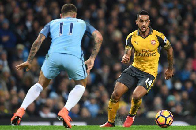 Arsenal's English midfielder Theo Walcott (R) vies with Manchester City's Serbian defender Aleksandar Kolarov during the Premier League match. (AFP) Arsenal's English midfielder Theo Walcott (R) vies with Manchester City's Serbian defender Aleksandar Kolarov during the Premier League match. (AFP)
