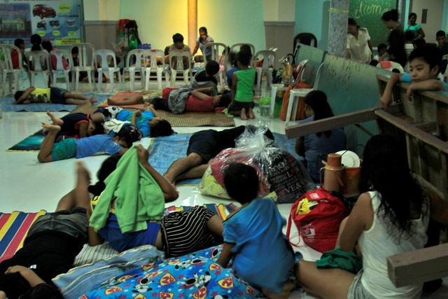 Residents celebrating Christmas Day at the evacuation centre take a break before Typhoon Nock-ten is expected to strike Legazpi City, Albay province, central Philippines. (Reuters Photo) Residents celebrating Christmas Day at the evacuation centre take a break before Typhoon Nock-ten is expected to strike Legazpi City, Albay province, central Philippines. (Reuters Photo)
