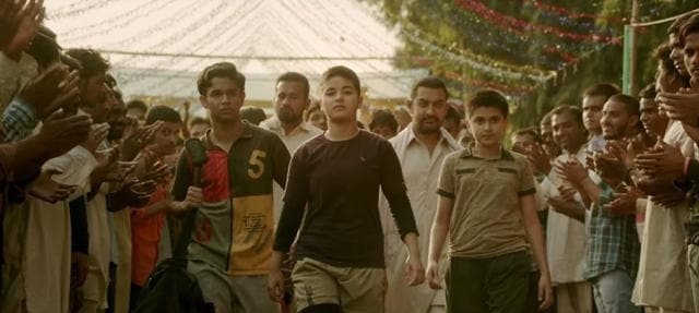 The girls must wrestle, Geeta must win to keep up the honour of the father, the nation and make herself into an icon – a burden enough to crush an individual. (YouTube)