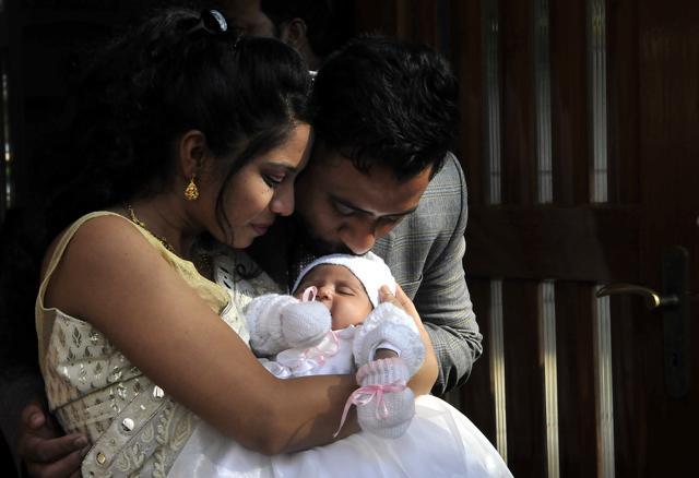 A couple greet their little one after the morning mass on the day of Christmas in Indore. (Arun Mondhe/ HT photo) A couple greet their little one after the morning mass on the day of Christmas in Indore. (Arun Mondhe/ HT photo)
