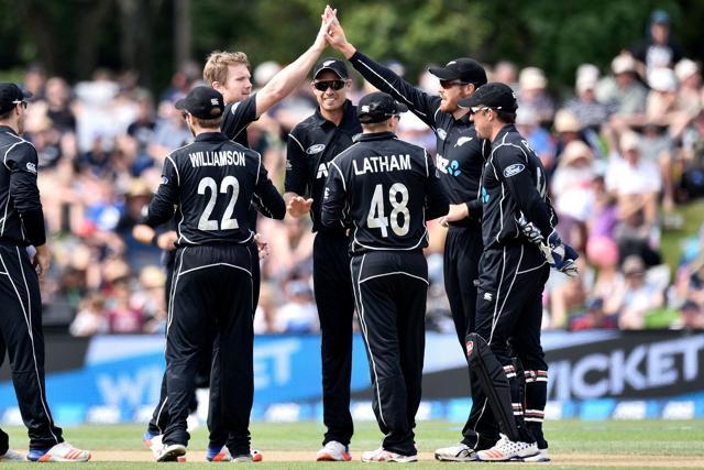 New Zealand's Jimmy Neesham (back L) high-fives teammate Martin Guptill (back R) as New Zealand celebrate after Bangladesh's Soumya Sarkar’s dismissal. (AFP)