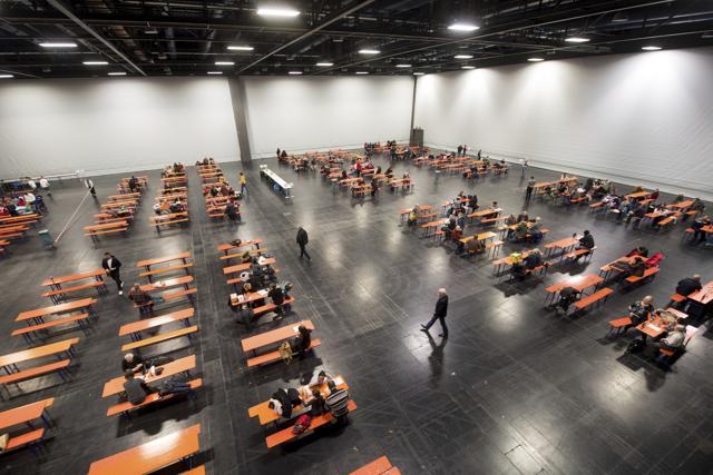 People wait inside an exhibition hall in Augsburg, Germany. Thousands of people in the German town of Augsburg have temporarily left Christmas presents and decorations behind while authorities disarm a World War II bomb. (AP Photo) People wait inside an exhibition hall in Augsburg, Germany. Thousands of people in the German town of Augsburg have temporarily left Christmas presents and decorations behind while authorities disarm a World War II bomb. (AP Photo)