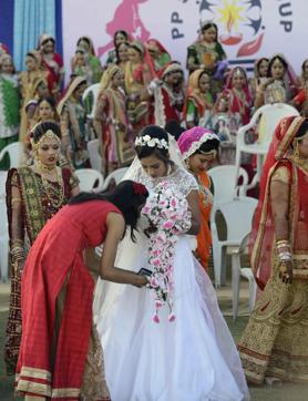 A Christian bride-to-be, Daxa, is helped by her friend at the mass wedding. (AFP) A Christian bride-to-be, Daxa, is helped by her friend at the mass wedding. (AFP)