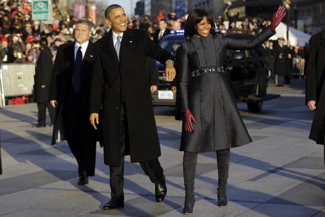 Michelle Obama in a coat and dress by American designer Thom Browne. Michelle Obama in a coat and dress by American designer Thom Browne.