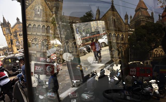 A reflection of the BMC building is seen on the windshield of a car parked on a packed road in Mumbai. (Arijit Sen/ HT Photo)
