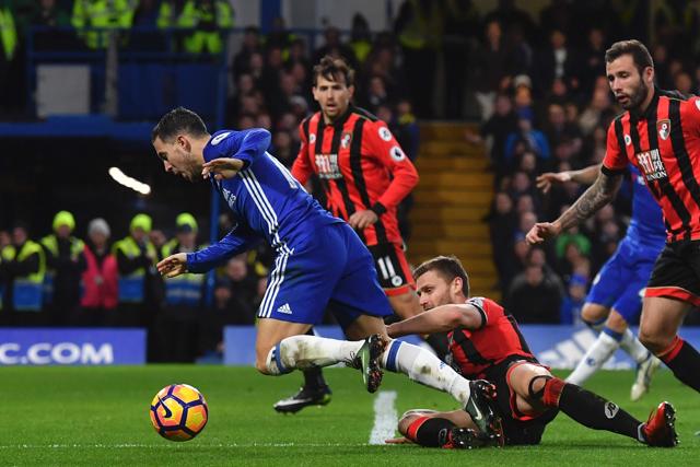 Chelsea Football Club's Belgian player Eden Hazard is brought down in the box by Bournemouth's defender Simon Francis at Stamford Bridge in London on Monday. (AFP) Chelsea Football Club's Belgian player Eden Hazard is brought down in the box by Bournemouth's defender Simon Francis at Stamford Bridge in London on Monday. (AFP)